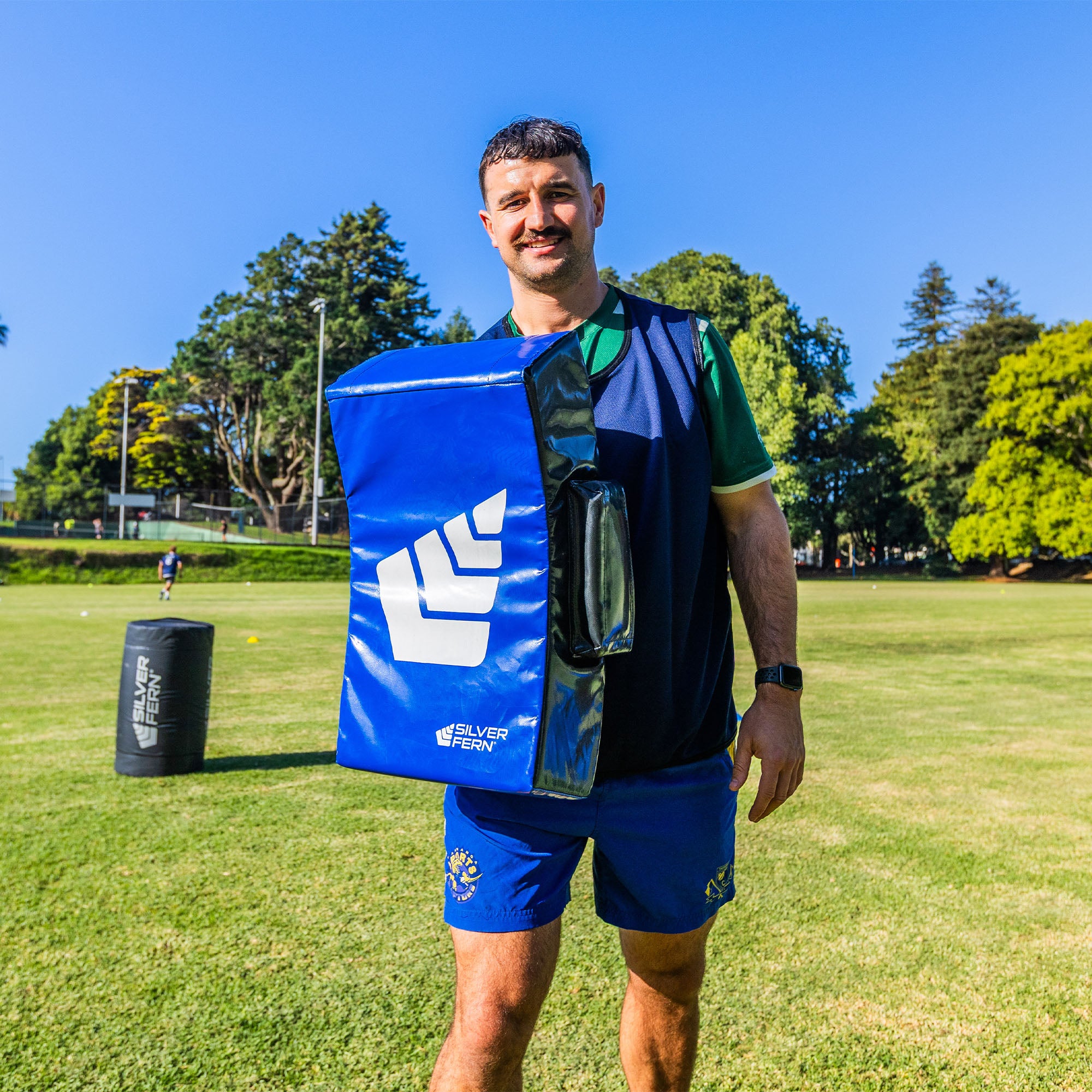 Hit Shield Profile Curved, lifestyle shot, rugby player holding hit pad at chest level.