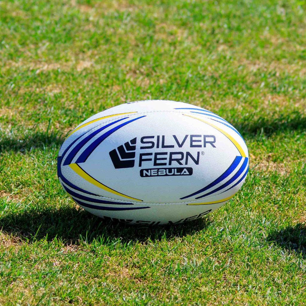 Silver Fern Nebula Match Size 5, Lifestyle shot, sitting on a rugby field