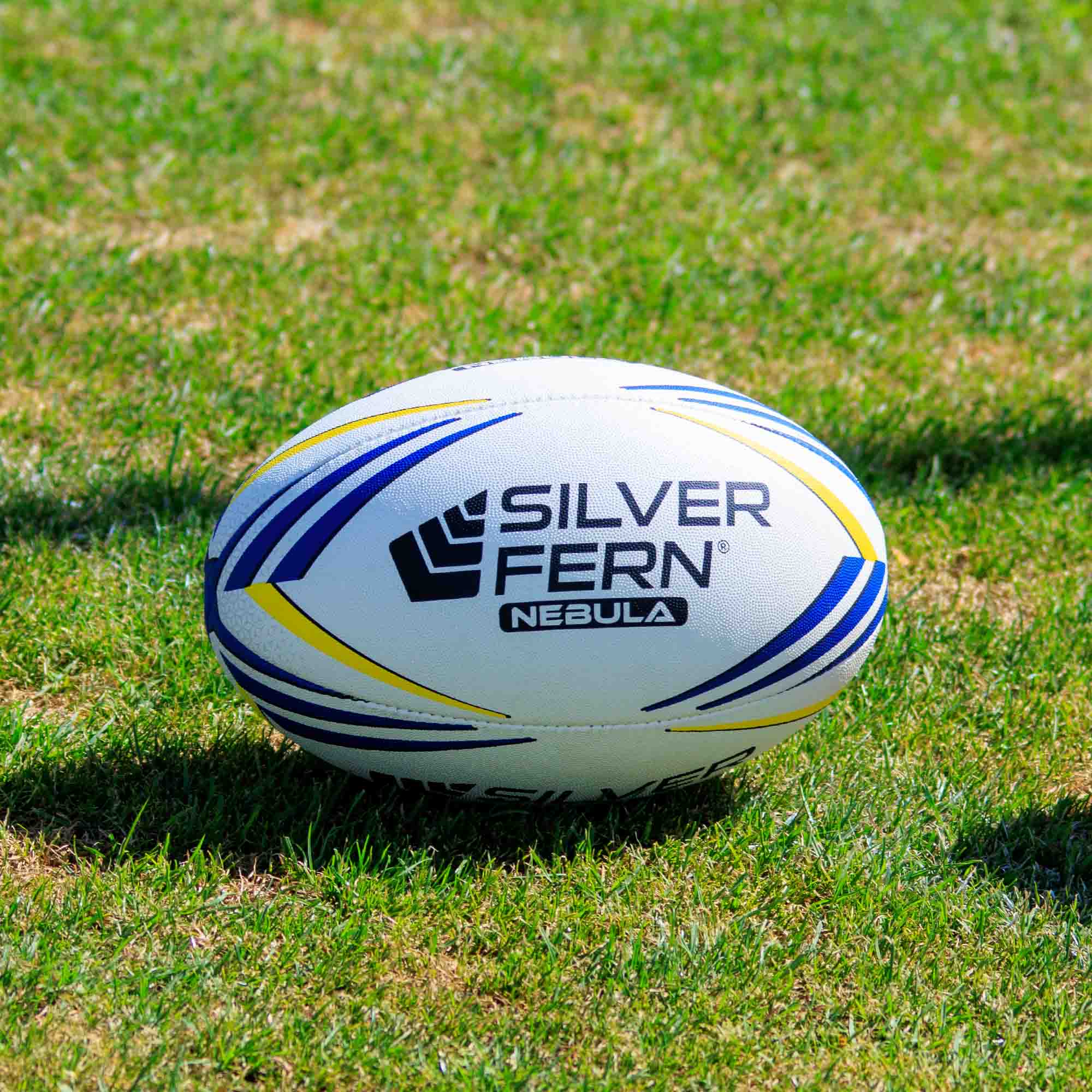 Silver Fern Nebula Match Size 5, Lifestyle shot, sitting on a rugby field