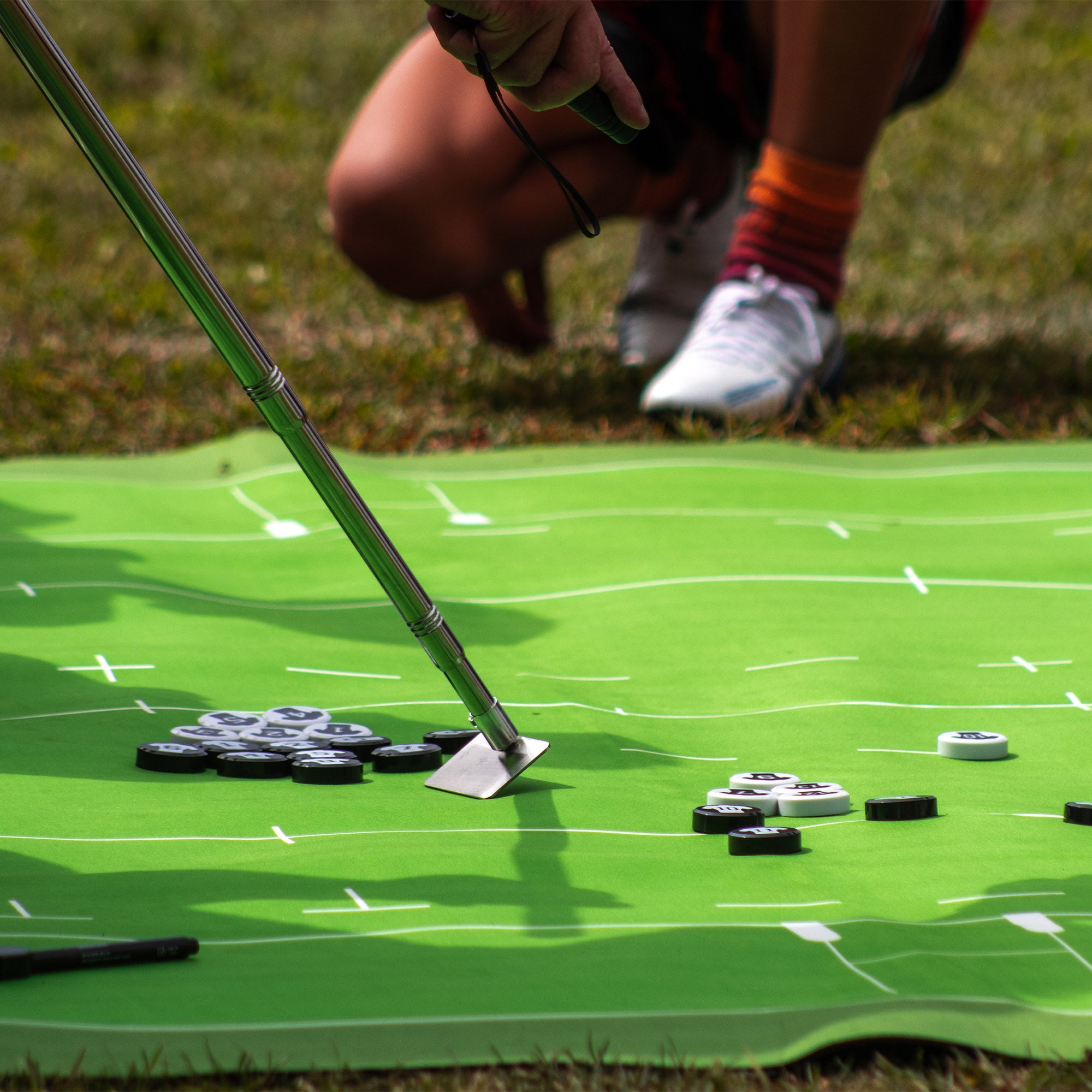 Silver Fern Rugby Union Coaching Mat, lifestyle shot, close-up of coach moving strategy markers with stick