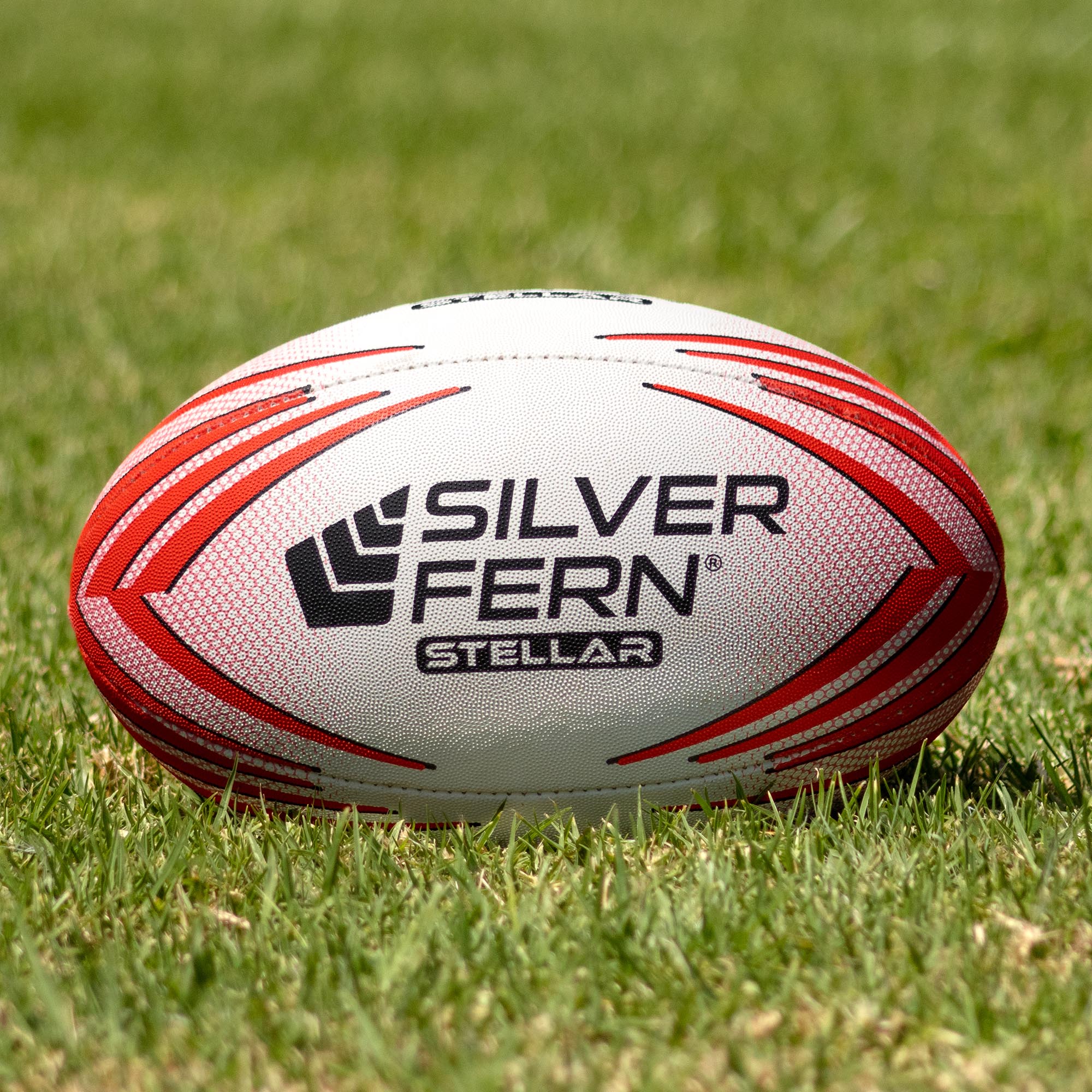 Silver Fern Stellar Premium Trainer Size 5, Lifestyle shot, sitting on a rugby field