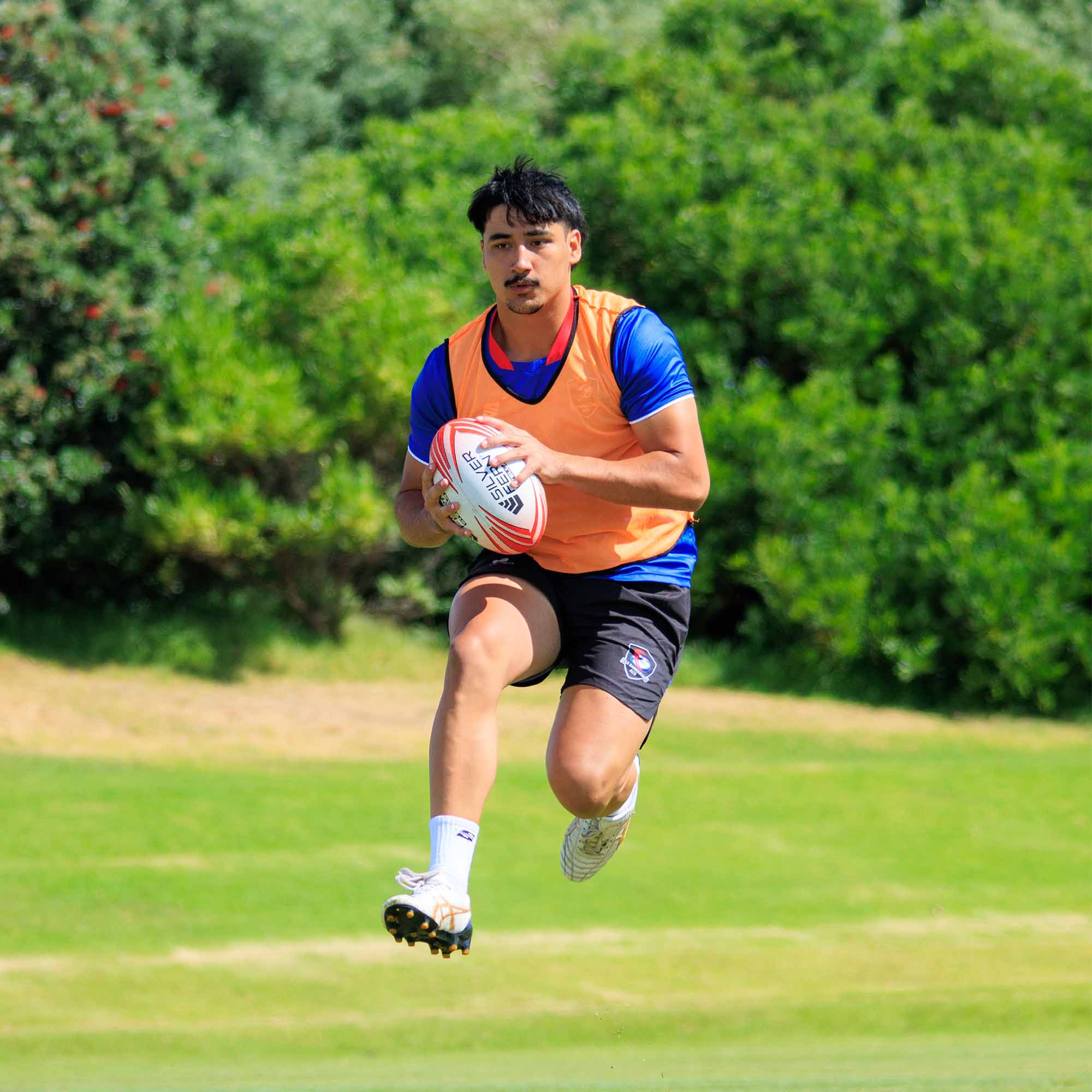 Silver Fern Rugby Premium Trainer Stellar Ball, Red, Size 5, player running with ball in hand, lifestyle.